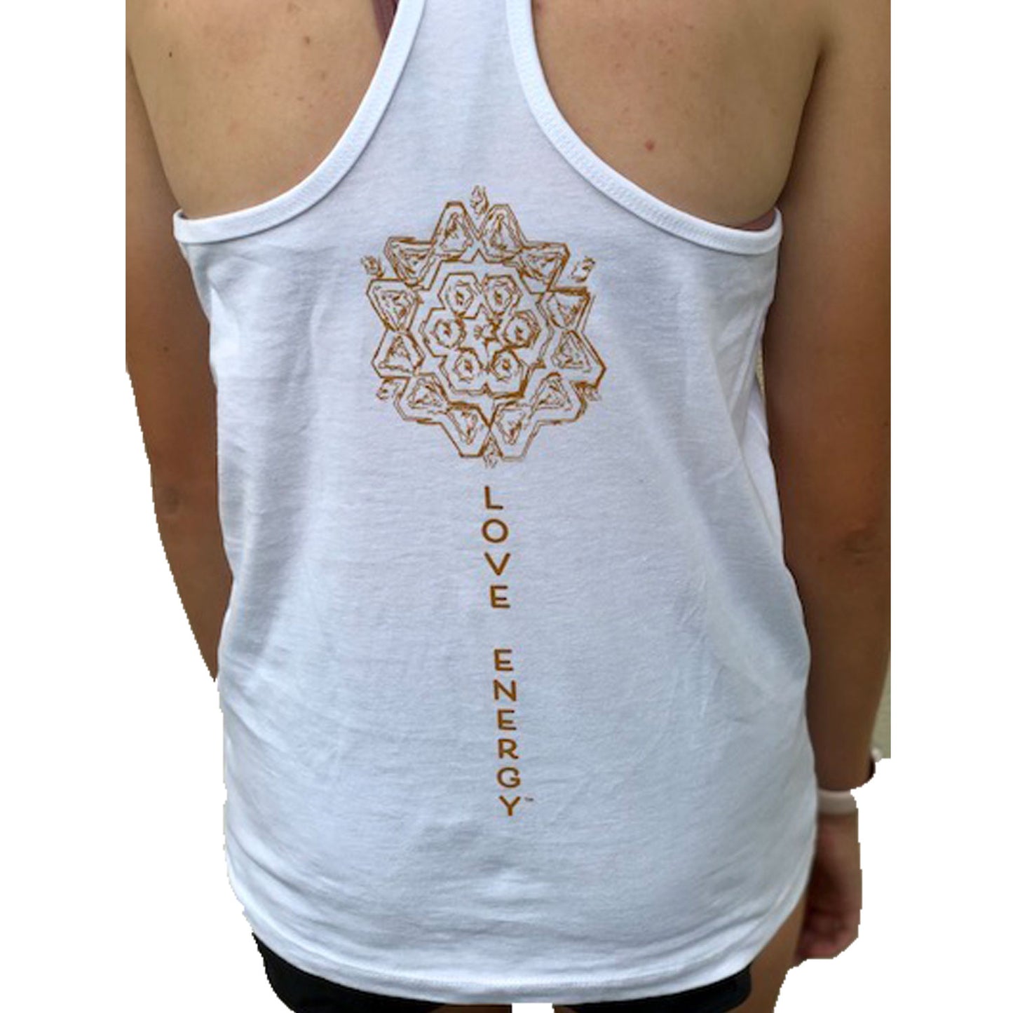 On the back of a white racer back tank top sits a bronze mandala with the words Love Energy running down the spine in bronze. The front of the top has Love Energy in bronze on the left chest